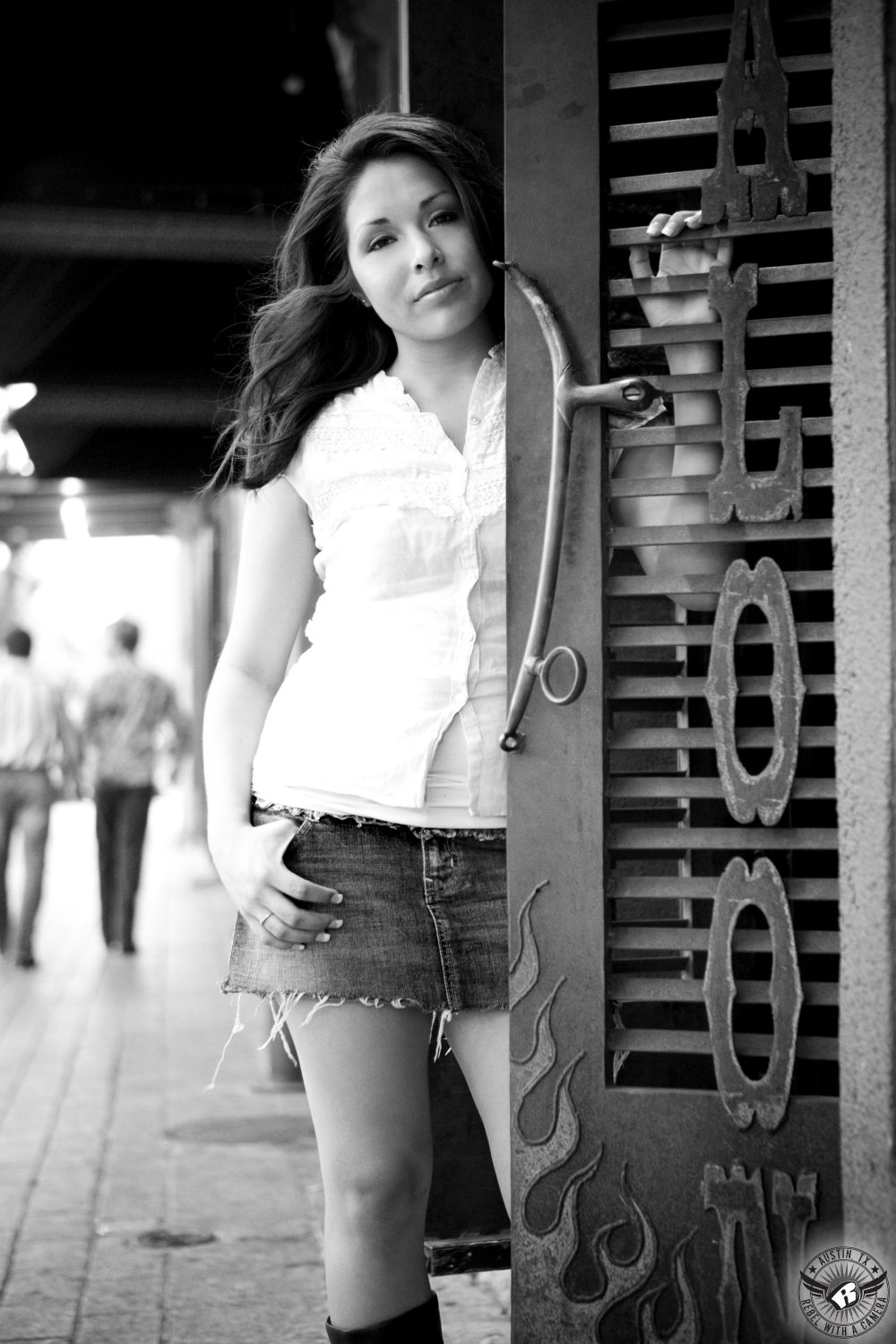 Downtown Austin high school senior portraits of girl in shorts and boots with hair and makeup by Divaz Fabula.