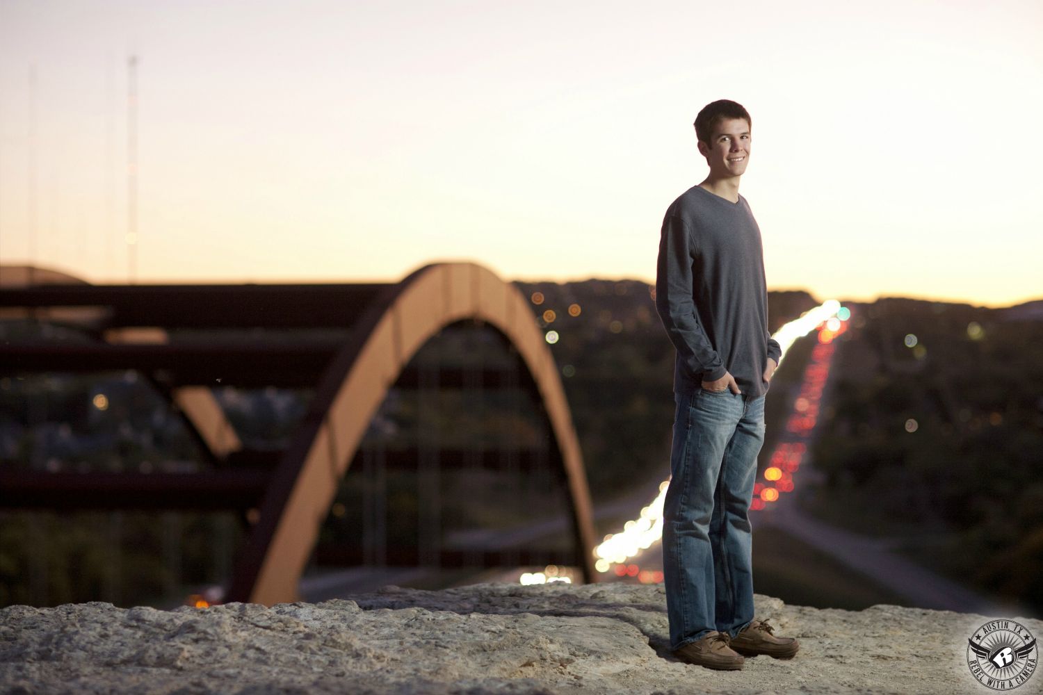 Picture of young man in sweater and jeans taken at Austin senior portrait location - 360 Bridge overlook.