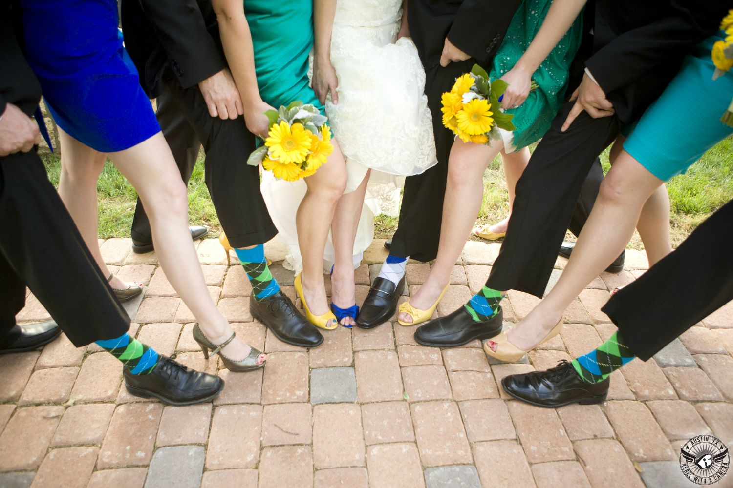 Fun and whimsical image of the brightly colored shoes and socks of the wedding party that are green and blue with yellow bouquets by Bouquets of Austin at Nature's Point Austin wedding venue.