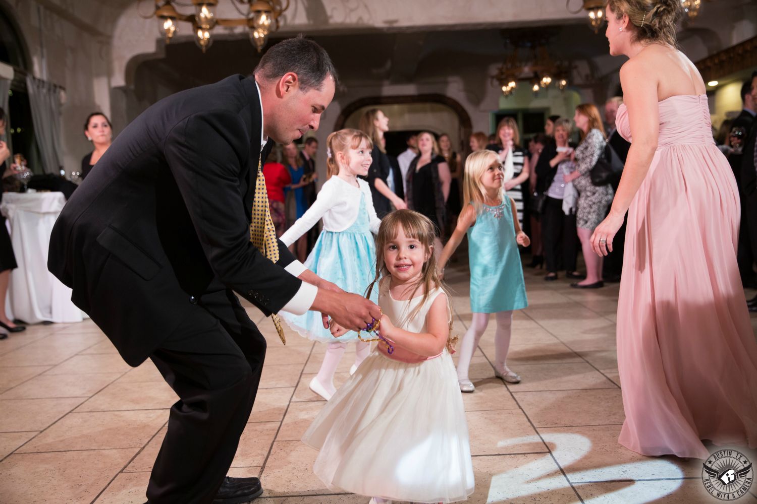 Picture of dad dancing with flower girl at wedding reception at Villa Antonia Austin wedding venue by Austin wedding photographer.