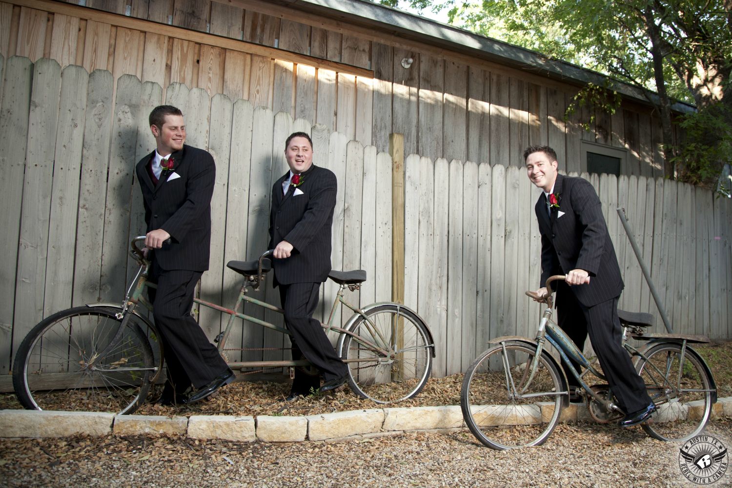 Austin wedding photogrpher takes fun picture of groom and groomsmen on bicycles in fun pose and black tuxedos at the Inn at Salado wedding venue in Texas.