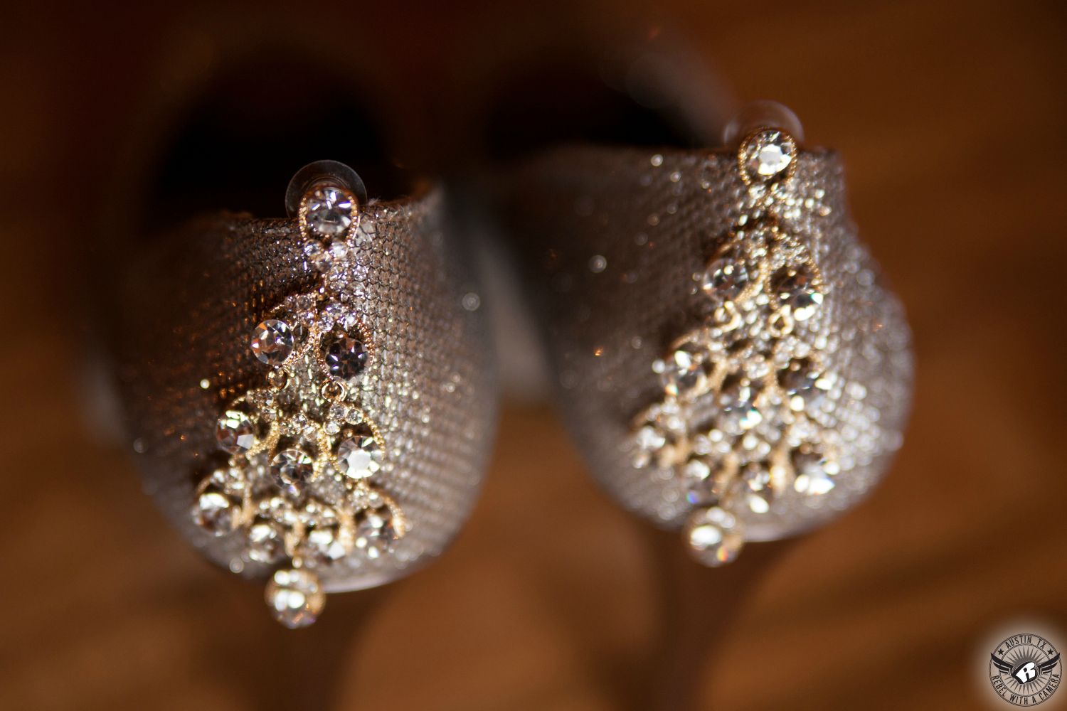 Picture of dangly, sparkly earrings on the back of silver high heels for the bride at Gabriel Springs wedding venue in the Austin area taken by Austin wedding photographer.