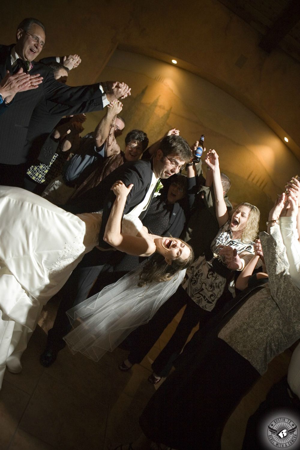 Picture of groom dipping bride dramatically while they dance their first dance at their wedding reception at the Flat Creek Estate Winery in Marble Falls, Texas, taken by Austin wedding photographer, Rebel with a Camera.