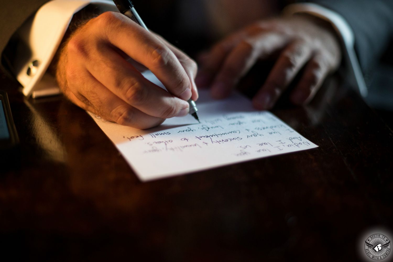 Austin wedding photography of groom writing love note to his bride on their wedding day at Green Pastures Austin wedding venue.