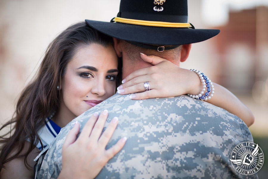 Army engagement pictures in Texas soldier and bride looks over his shoulder