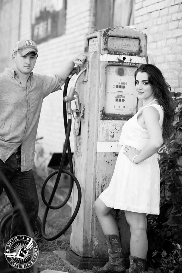 Army engagement session in Texas bride and groom black and white picture with old gas pump in rustic country town
