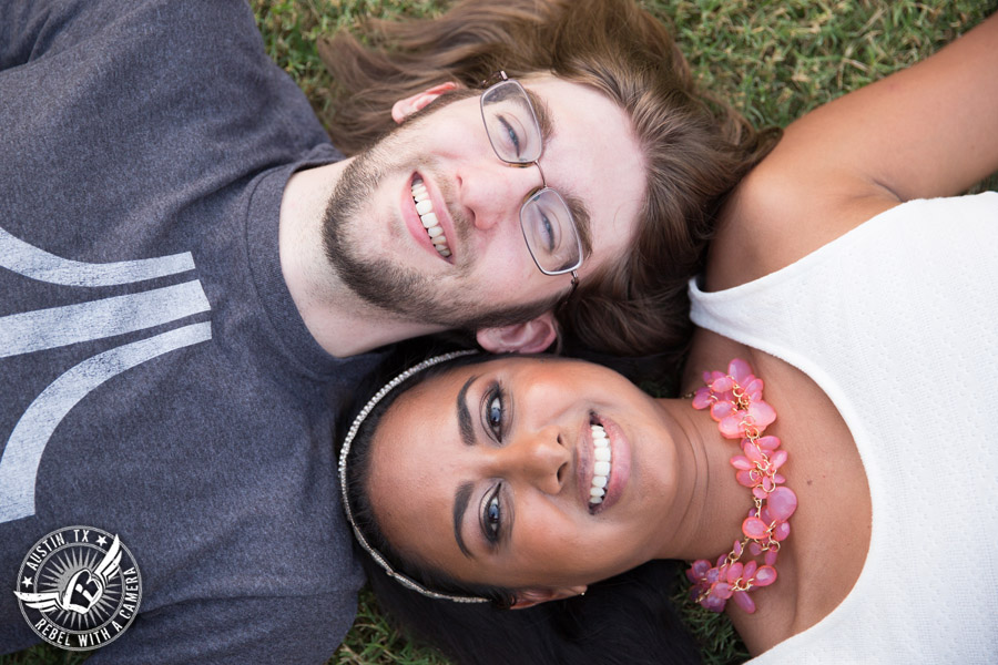 Fun Butler Park engagement session in Austin lying the the grass