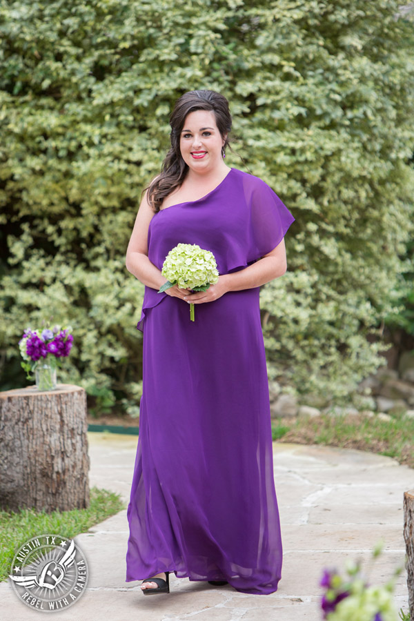 Sage Hall wedding photos at Texas Old Town bridesmaid coming down aisle in purple off the shoulder dress with pale green hydrangea bouquet