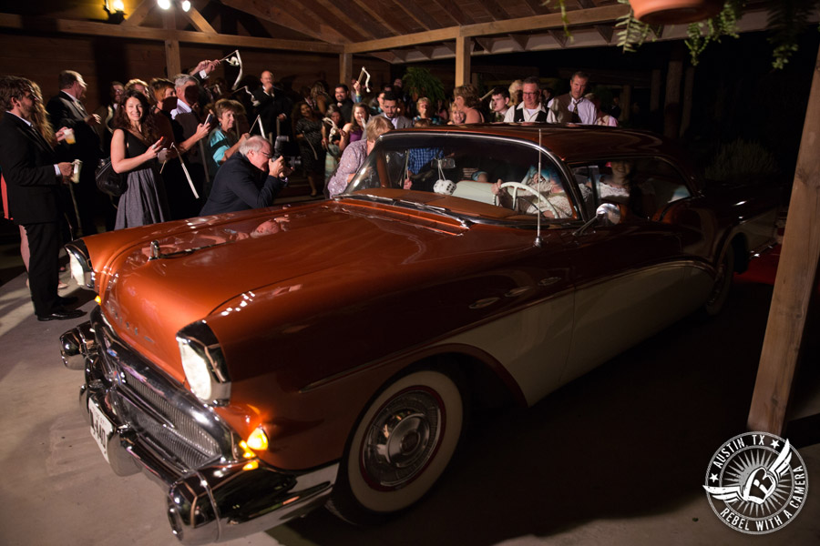 Sage Hall wedding photos at Texas Old Town bride and groom exit the wedding reception in vintage car