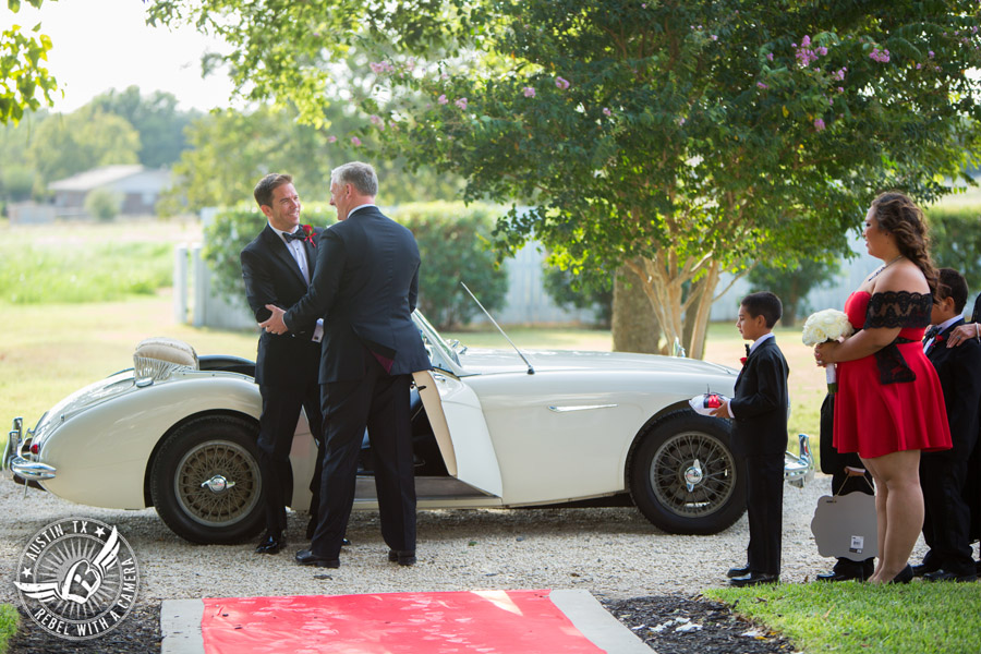 Taylor Mansion wedding photo groom rides white convertible to the wedding ceremony