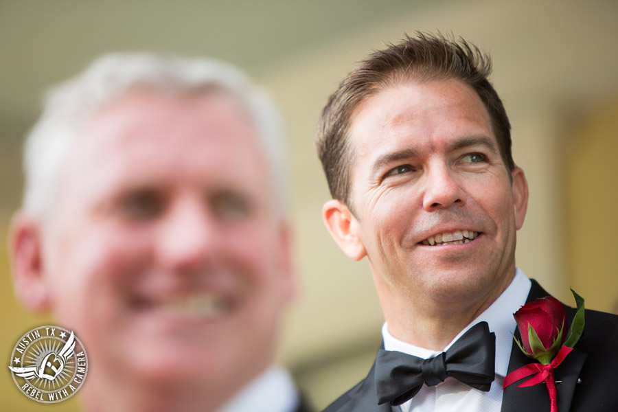 Taylor Mansion wedding photo groom sees bride coming down the aisle at wedding ceremony