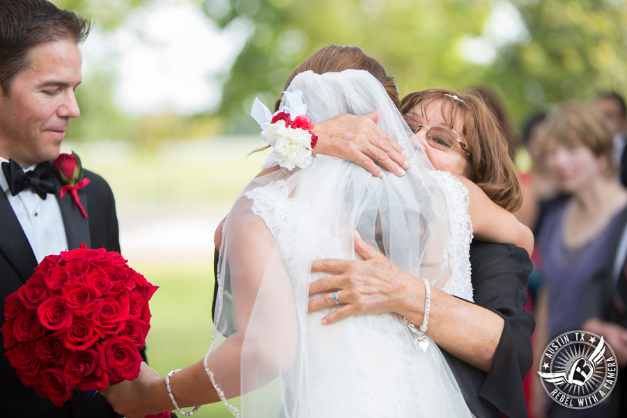 Taylor Mansion wedding photo bride hugs mother at wedding ceremony