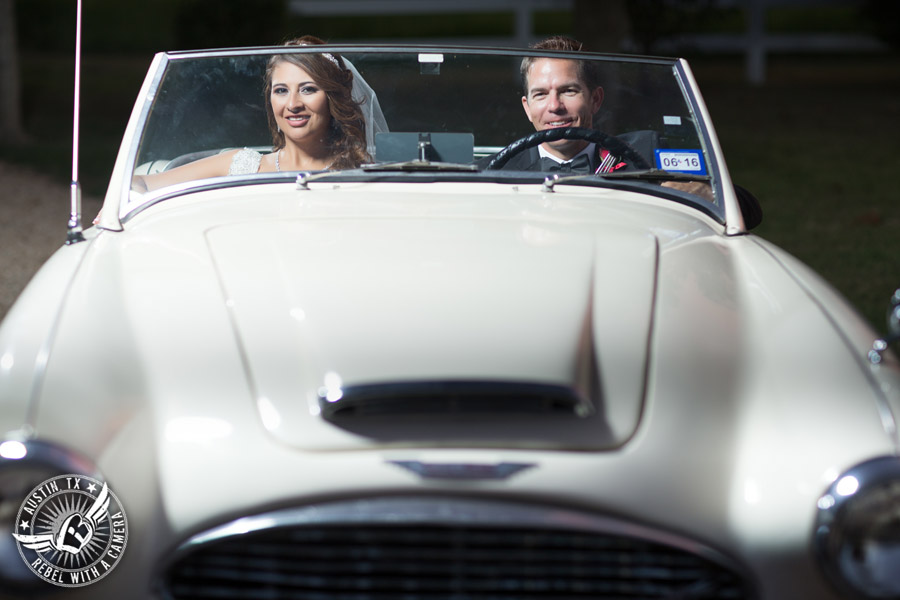 Taylor Mansion wedding photo of bride and groom with white convertible