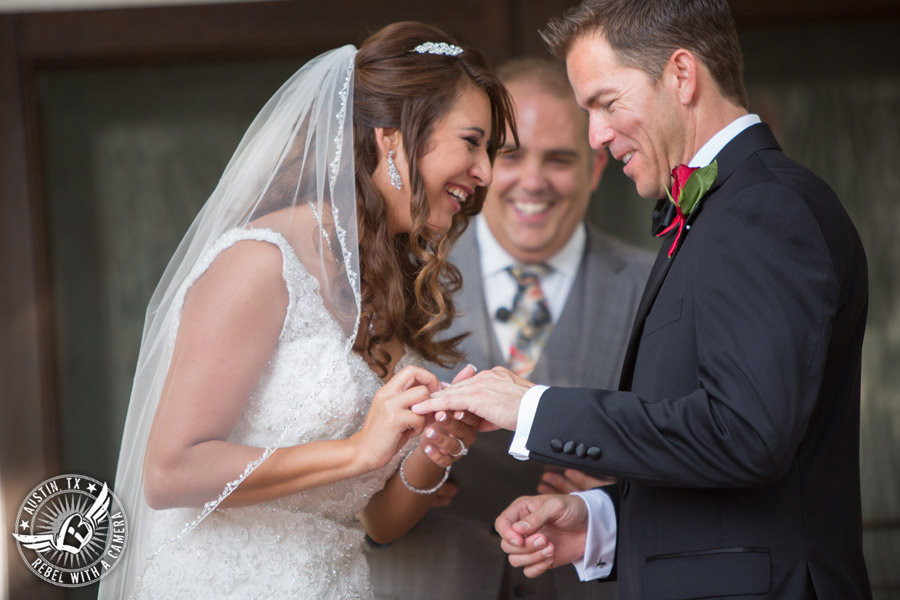 Taylor Mansion wedding photo of bride putting ring on groom's finger at wedding ceremony