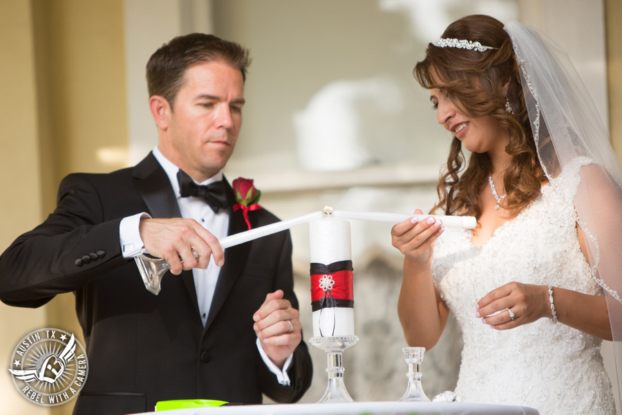 Taylor Mansion wedding photo of bride and groom lighting unity candle at wedding ceremony