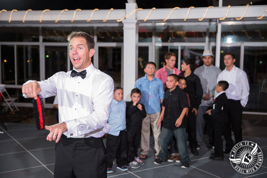 Taylor Mansion wedding photo groom throws the garter on the patio with 1st Class Entertainment DJ Jason