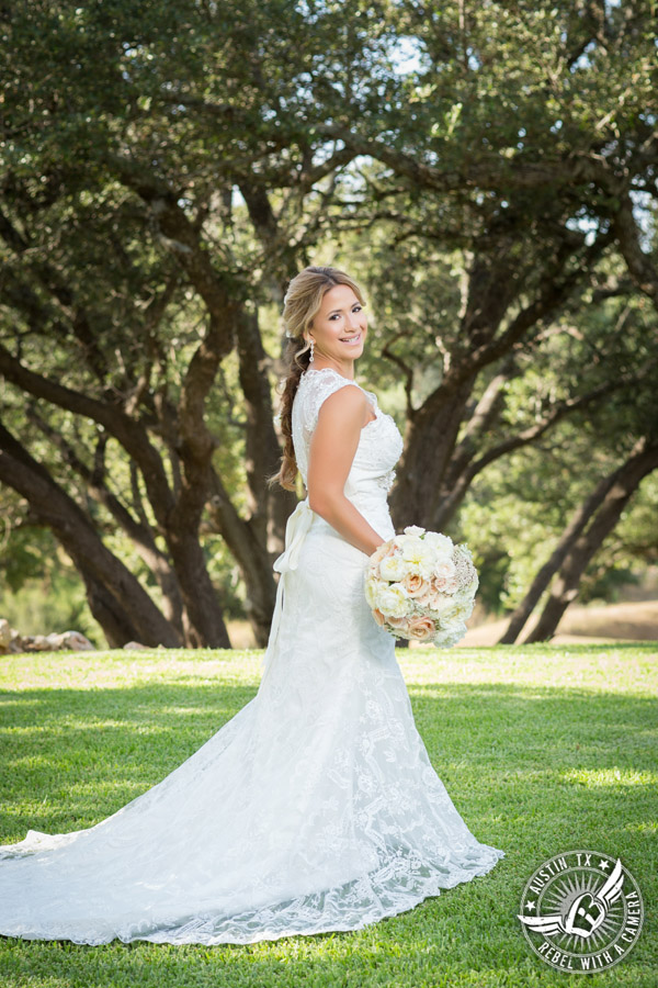 Gabriel Springs bridal portrait in Georgetown, Texas, with hair and makeup by Kiss by Katie and bouquet by Sixpence Floral Design at the Springs Events