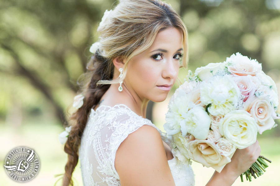 Gabriel Springs bridal portrait in Georgetown, Texas, with hair and makeup by Kiss by Katie and bouquet by Sixpence Floral Design at the Springs Events