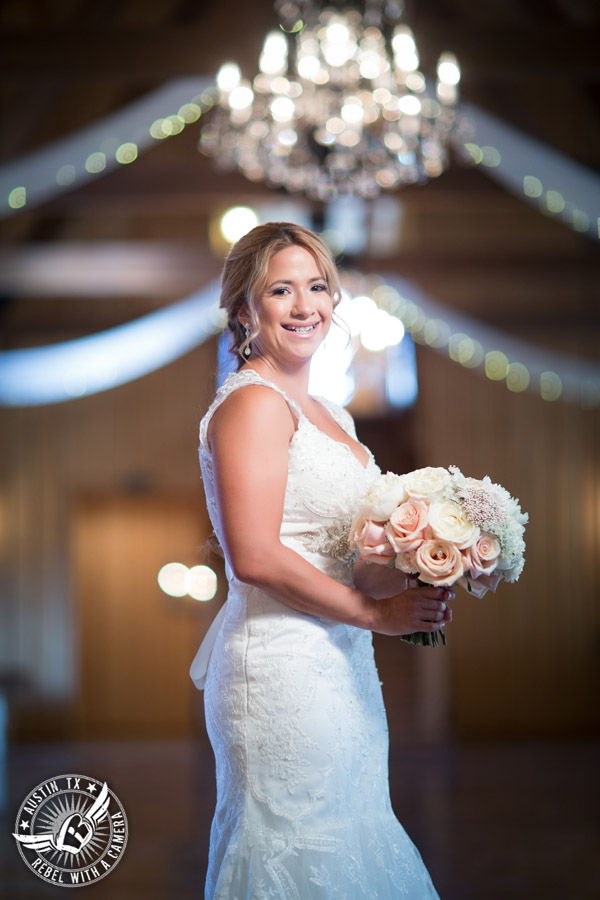 Gabriel Springs bridal portrait in Georgetown, Texas, with hair and makeup by Kiss by Katie and bouquet by Sixpence Floral Design at the Springs Events