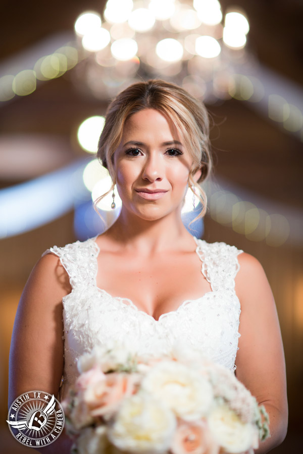 Gabriel Springs bridal portrait in Georgetown, Texas, with hair and makeup by Kiss by Katie and bouquet by Sixpence Floral Design at the Springs Events