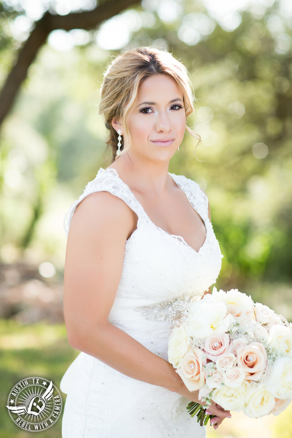 Gabriel Springs bridal portrait in Georgetown, Texas, with hair and makeup by Kiss by Katie and bouquet by Sixpence Floral Design at the Springs Events