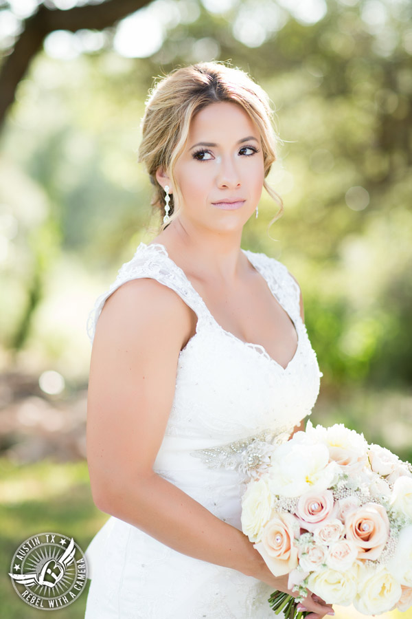 Gabriel Springs bridal portrait in Georgetown, Texas, with hair and makeup by Kiss by Katie and bouquet by Sixpence Floral Design at the Springs Events