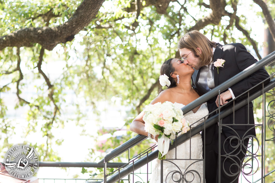 Austin wedding photographer at Olive and June - bride and groom kiss on stairs
