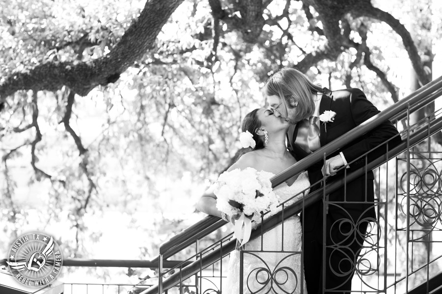 Austin wedding photographer at Olive and June - bride and groom kiss on stairs