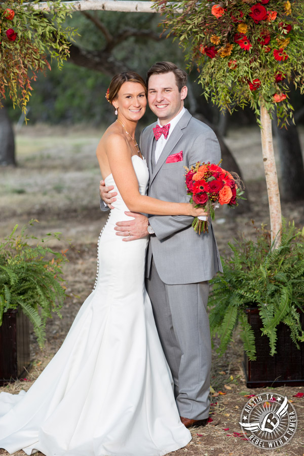 Hamilton Twelve wedding photos - bride and groom in front of arbor by the Flower Girl