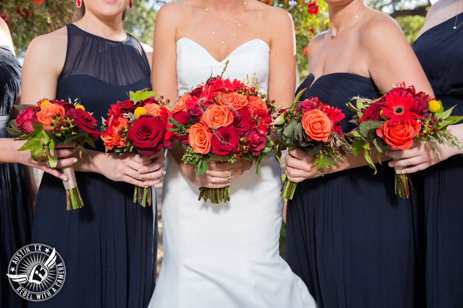 Hamilton Twelve wedding photos - bride and bridesmaids in navy dresses and red and orange bouquets by the Flower Girl