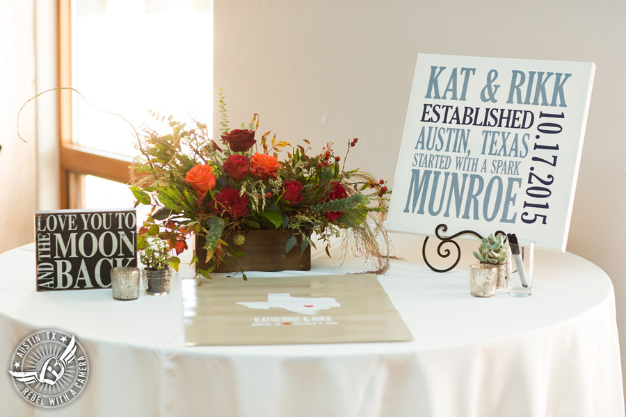 Hamilton Twelve wedding photos - sign in table and floral centerpiece by the Flower Girl with red and orange roses 