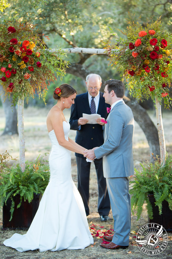 Hamilton Twelve wedding photos - bride groom hold hands during wedding ceremony