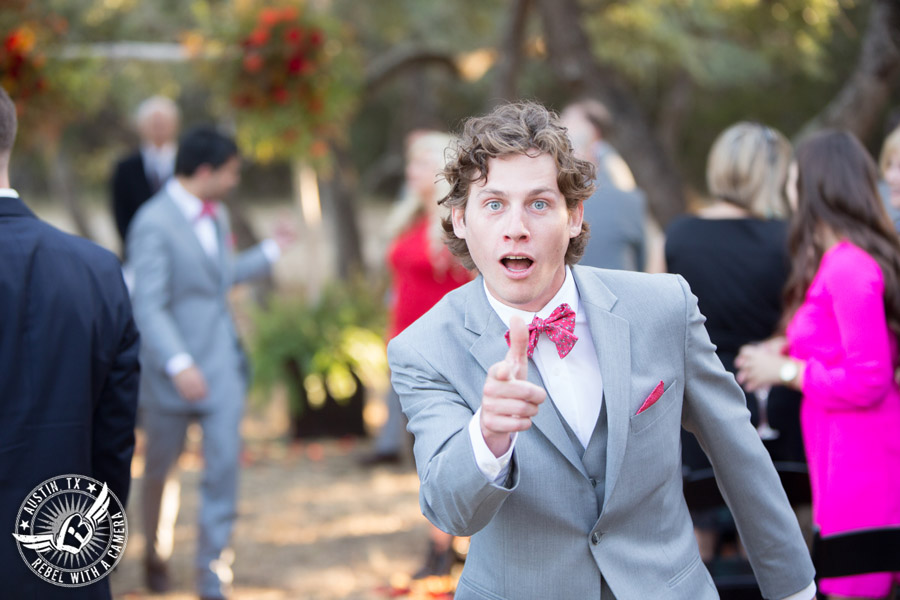 Hamilton Twelve wedding photos - groomsman walks down the aisle at end of wedding ceremony