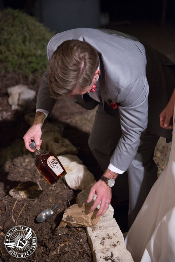 Hamilton Twelve wedding photos - groom digs up buried bottle of bourbon