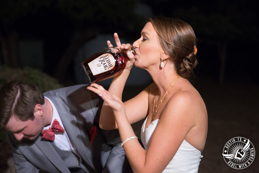 Hamilton Twelve wedding photos - bride drinks from buried bottle of bourbon
