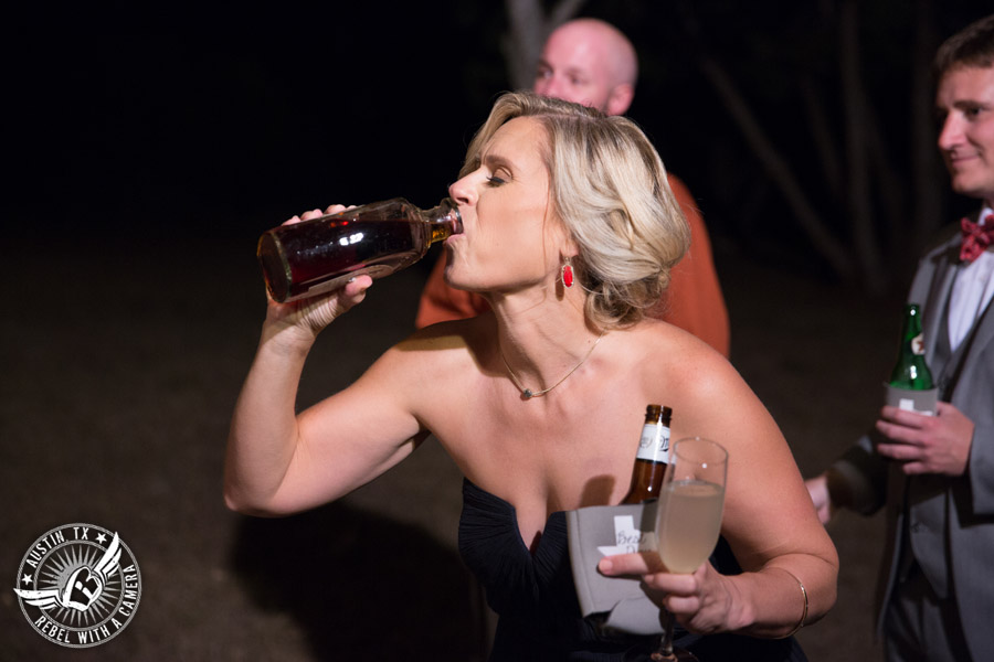 Hamilton Twelve wedding photos - bridesmaid drinks from buried bottle of bourbon