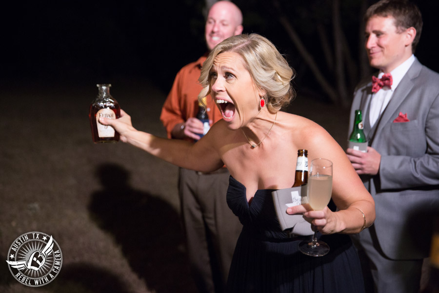 Hamilton Twelve wedding photos - bridesmaid drinks from buried bottle of bourbon