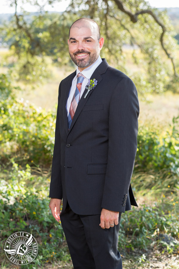 Wedding pictures at Thurman's Mansion at the Salt Lick - groom under the oak trees - boutonniere by Verbena Floral Design