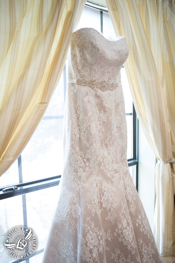 Wedding pictures at Thurman's Mansion at the Salt Lick - strapless lace bridal gown in the window in the bride's room