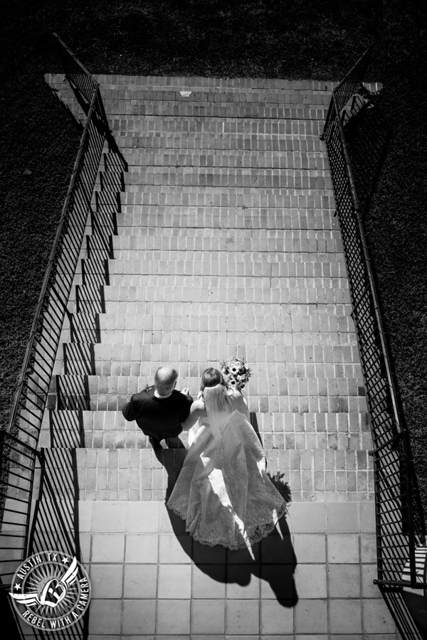 Wedding pictures at Thurman's Mansion at the Salt Lick - bride and father walk down the steps to the wedding ceremony