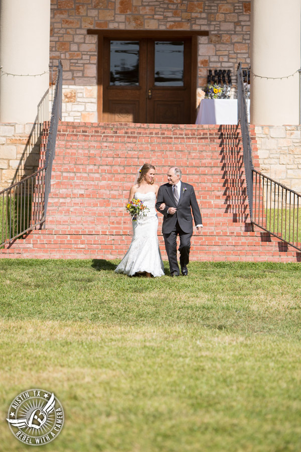 Wedding pictures at Thurman's Mansion at the Salt Lick - bride and father walk down to the wedding ceremony