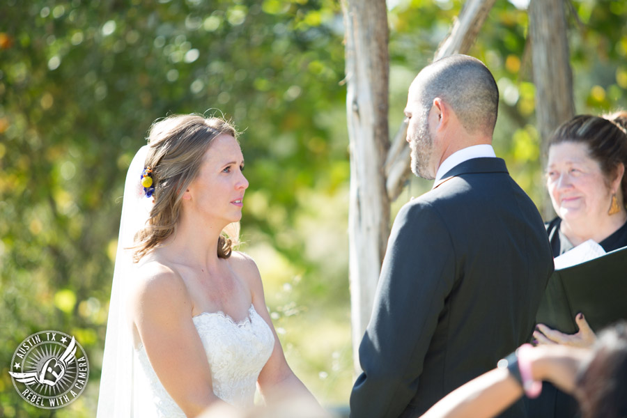 Wedding pictures at Thurman's Mansion at the Salt Lick - bride looks at the groom during the wedding ceremony