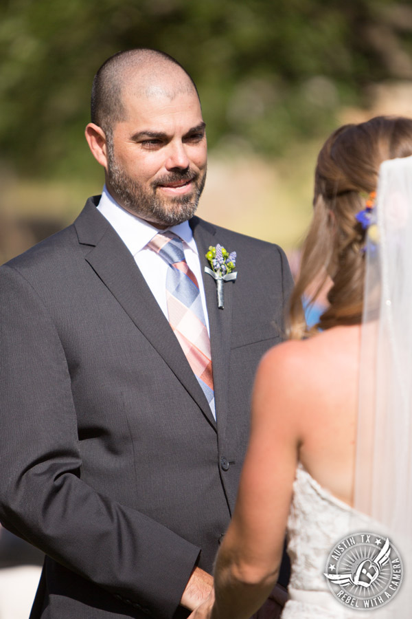 Wedding pictures at Thurman's Mansion at the Salt Lick - groom looks at the bride during the wedding ceremony