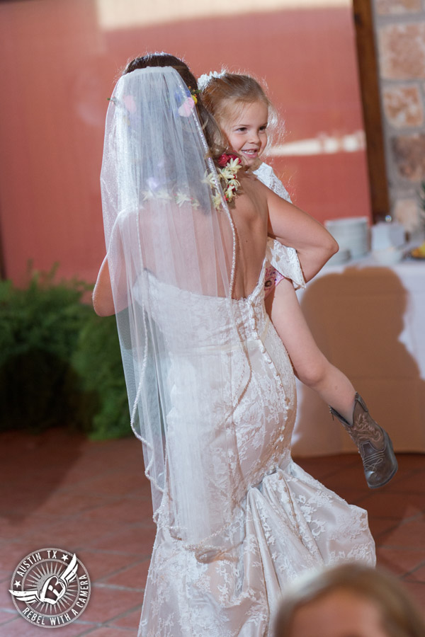 Wedding pictures at Thurman's Mansion at the Salt Lick - flower girl dances with the bride at the wedding reception - Live Oak DJ