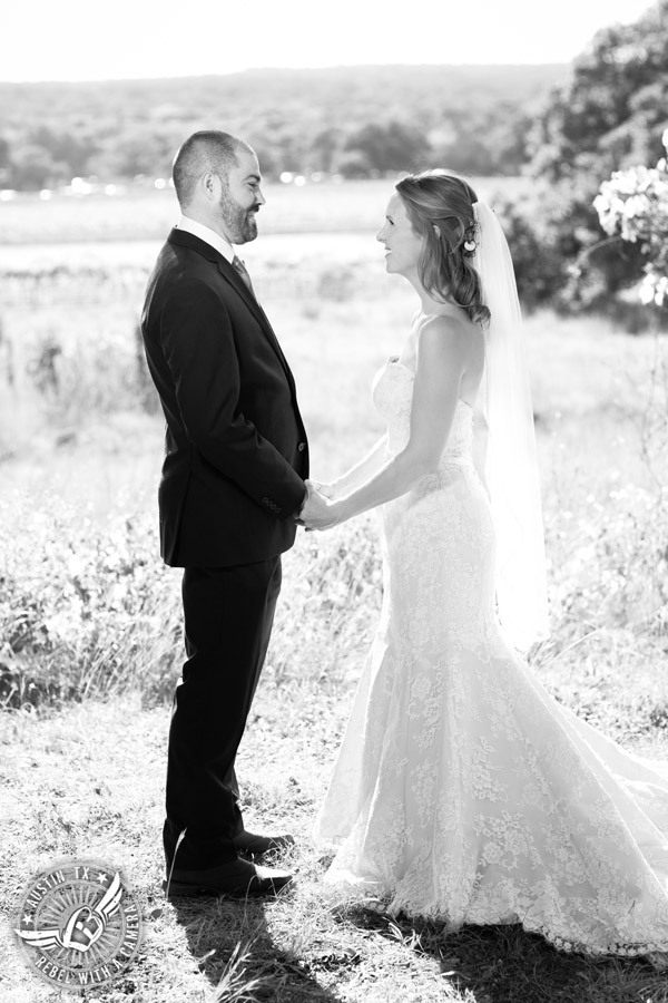 Wedding pictures at Thurman's Mansion at the Salt Lick - bride and groom hold hands in black and white