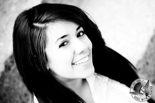 Black and white close-up portrait of a smiling brunette woman in Austin