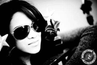 Black and white Austin senior portrait of a woman wearing sunglasses in Austin, TX.