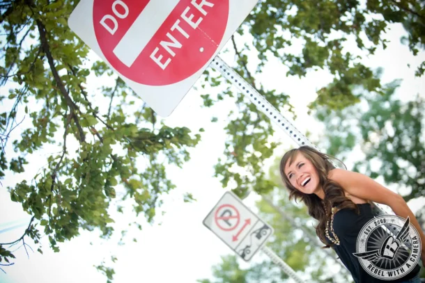 Smiling woman beneath a Do Not Enter sign in Austin in Austin, TX.