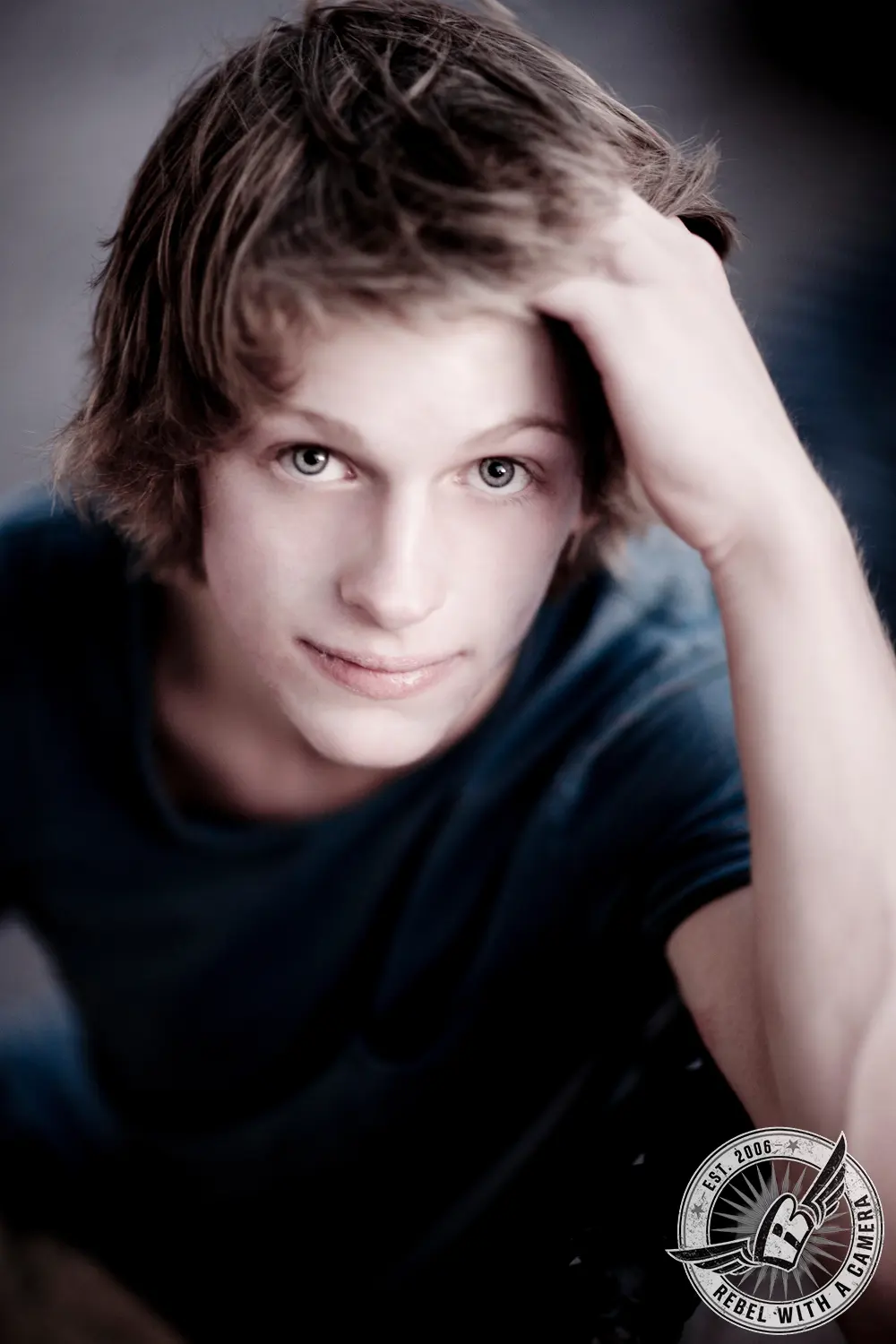 Austin senior portrait close-up of a young man with his hand in his hair in Austin, TX.