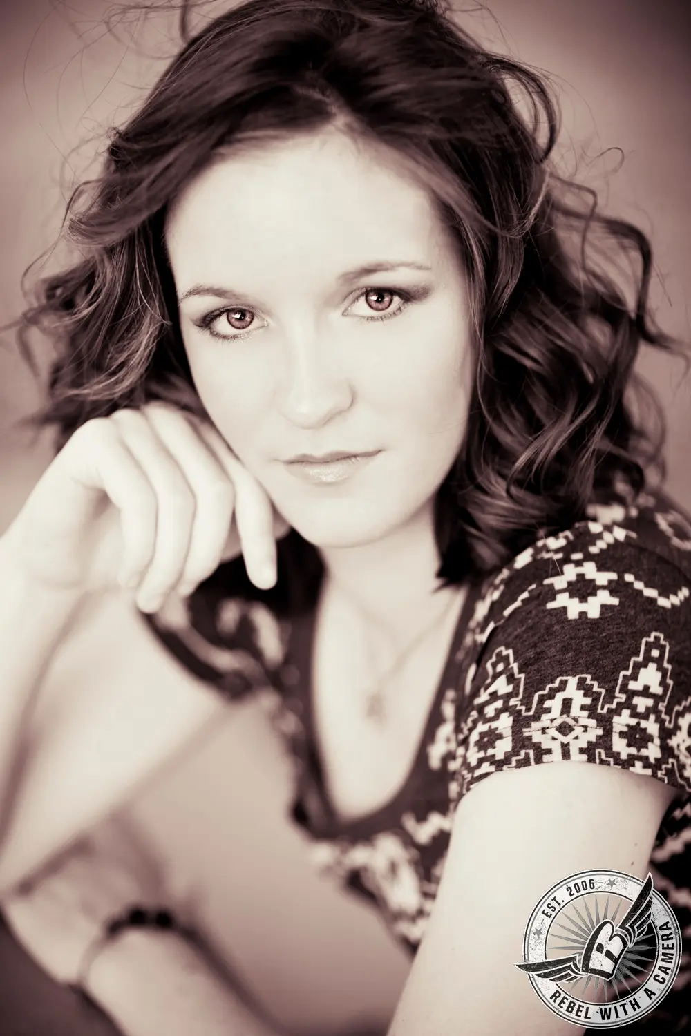 Sepia Austin senior portrait of a woman resting her chin on her hand in Austin, TX.
